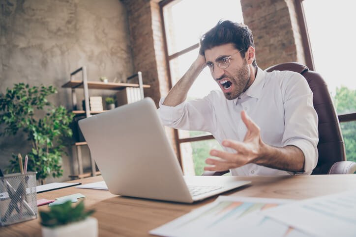 Profile side photo of frustrated crazy senior marketer, manager find plan mistake in review research feel burnout scream sit desktop in loft workstation